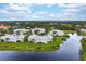 Aerial view of lakefront condo, showcasing patio at 905 Addington Ct # 203, Venice, FL 34293