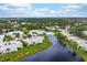 Aerial view of waterfront homes and lush landscape at 905 Addington Ct # 203, Venice, FL 34293