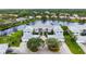 Two-story building near a lake with beautiful landscaping at 905 Addington Ct # 203, Venice, FL 34293
