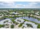 Aerial view of community, showcasing lake and homes at 905 Addington Ct # 203, Venice, FL 34293