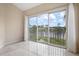 Bedroom with sliding doors opening to a scenic balcony overlooking a lake at 905 Addington Ct # 203, Venice, FL 34293