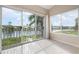 Bedroom with sliding doors and window offering lake and community views at 905 Addington Ct # 203, Venice, FL 34293