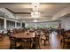 Spacious dining room with multiple tables and chairs, perfect for gatherings at 905 Addington Ct # 203, Venice, FL 34293