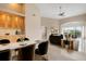 Open concept dining room with marble table and modern chairs at 905 Addington Ct # 203, Venice, FL 34293