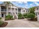 Two-story condo building with stairs and landscaping at 905 Addington Ct # 203, Venice, FL 34293