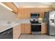 Modern kitchen with stainless steel appliances at 905 Addington Ct # 203, Venice, FL 34293