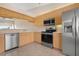 Kitchen with stainless steel appliances and wood cabinets at 905 Addington Ct # 203, Venice, FL 34293