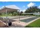Outdoor lawn bowling amenity with covered seating for shade at 905 Addington Ct # 203, Venice, FL 34293
