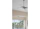 Bright living room with ceiling fans and sliding doors leading to a balcony at 905 Addington Ct # 203, Venice, FL 34293