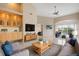 Spacious living room featuring a large TV, comfy sofas, and a view of the water at 905 Addington Ct # 203, Venice, FL 34293