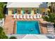 Community pool with lounge chairs and patio tables at 905 Addington Ct # 203, Venice, FL 34293