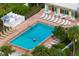 Aerial view of community pool with ample seating, tables, and lush landscaping at 905 Addington Ct # 203, Venice, FL 34293
