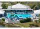 Community pool with surrounding lounge area at 905 Addington Ct # 203, Venice, FL 34293