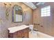 Stylish bathroom with leopard print wallpaper, marble vanity, and updated fixtures at 9750 53Rd E Dr, Bradenton, FL 34211