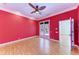 Bright bedroom featuring hardwood floors, french doors, and a ceiling fan at 9750 53Rd E Dr, Bradenton, FL 34211
