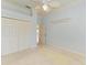 Bedroom with light blue walls, ceiling fan and double door closet at 9750 53Rd E Dr, Bradenton, FL 34211