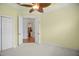 Bedroom featuring a closet and view into an adjacent room with stainless appliances at 9750 53Rd E Dr, Bradenton, FL 34211