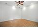 A clean, well-lit bedroom featuring a ceiling fan and wood-look floors at 9750 53Rd E Dr, Bradenton, FL 34211