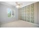 This bedroom features plantation shutters and decorative wallpaper at 9750 53Rd E Dr, Bradenton, FL 34211