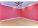 Spacious bedroom with hardwood floors and a ceiling fan at 9750 53Rd E Dr, Bradenton, FL 34211