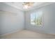 Bright bedroom with a ceiling fan, shuttered window, and inspiring quote at 9750 53Rd E Dr, Bradenton, FL 34211