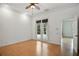 A cozy bedroom with white walls and French doors leading to a patio at 9750 53Rd E Dr, Bradenton, FL 34211