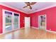 Bedroom with hardwood floors, french doors opening to a patio, and access to a bathroom at 9750 53Rd E Dr, Bradenton, FL 34211