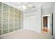 Bedroom with a ceiling fan, closet, and view into an adjacent room at 9750 53Rd E Dr, Bradenton, FL 34211