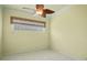 Well-lit bedroom with textured glass block window and ceiling fan at 9750 53Rd E Dr, Bradenton, FL 34211