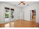 Bedroom with french doors, hardwood floors, and access to an adjacent bathroom at 9750 53Rd E Dr, Bradenton, FL 34211