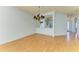 Bright dining room with hardwood floors and a view into the kitchen at 9750 53Rd E Dr, Bradenton, FL 34211