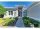 Welcoming entryway with landscaped walkway, lighting, and lush greenery at 9750 53Rd E Dr, Bradenton, FL 34211