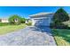 Single-story house with gray siding, two-car garage, and paved driveway at 9750 53Rd E Dr, Bradenton, FL 34211