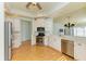 Eat-in kitchen with stainless steel appliances, white cabinetry, and hardwood floors at 9750 53Rd E Dr, Bradenton, FL 34211