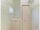 Functional laundry room with sink, storage cabinets, and hanging racks at 9750 53Rd E Dr, Bradenton, FL 34211