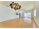 Large living room with hardwood floors, chandelier, and a wall-mounted TV at 9750 53Rd E Dr, Bradenton, FL 34211