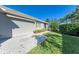 Landscaped side yard with patio and lawn at 9750 53Rd E Dr, Bradenton, FL 34211