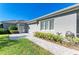 Neatly landscaped side yard with brick pathway at 9750 53Rd E Dr, Bradenton, FL 34211