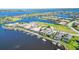Aerial view of waterfront home with private dock and boat lift in a luxury community at 1014 Overlook Ct, Bradenton, FL 34208