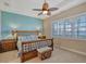 Spacious bedroom with water views, featuring a ceiling fan and large windows at 1014 Overlook Ct, Bradenton, FL 34208