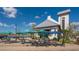Outdoor cafe with tables, umbrellas, and a white building at 1014 Overlook Ct, Bradenton, FL 34208