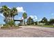 Gated entrance to the community featuring palm trees and brick pavers at 1014 Overlook Ct, Bradenton, FL 34208