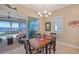 Bright dining area with wooden table and chairs, overlooking a patio and water view at 1014 Overlook Ct, Bradenton, FL 34208