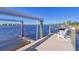 Private dock with boat lift and seating area, offering waterfront access at 1014 Overlook Ct, Bradenton, FL 34208