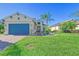 One-story house with blue garage door and nicely landscaped yard at 1014 Overlook Ct, Bradenton, FL 34208