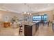 Open floor plan with kitchen island, stainless steel appliances, and living area at 1014 Overlook Ct, Bradenton, FL 34208