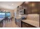 Modern kitchen featuring granite countertops and stainless steel appliances at 1014 Overlook Ct, Bradenton, FL 34208