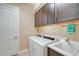 Laundry room with washer, dryer, and cabinets at 1014 Overlook Ct, Bradenton, FL 34208