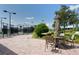 Relaxing patio area with table, chairs, and umbrella near tennis courts at 1014 Overlook Ct, Bradenton, FL 34208