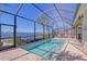 Enclosed heated pool with a view of the waterway at 1014 Overlook Ct, Bradenton, FL 34208
